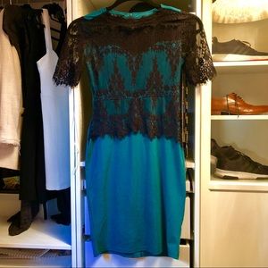 Turquoise party dress with black lace.